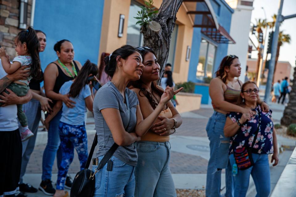 Jacky Puentes, center left, and Jennifer Perales, both of Desert Hot Springs, prepare to purchase items from a food truck on Palm Drive at Pierson Boulevard during Friday Nights on Pierson, in downtown Desert Hot Springs, Calif., on Fri., May 12, 2023.