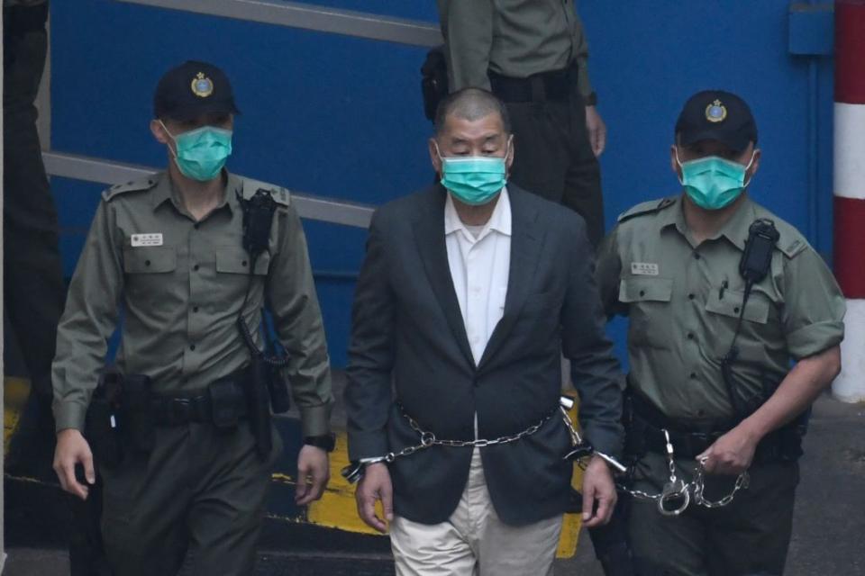 Owner of Apple Daily Newspaper Jimmy Lai is seen shackled as prison guards escort him to a prison van at Lai Chi Kok Reception Center in Hong Kong, China. 