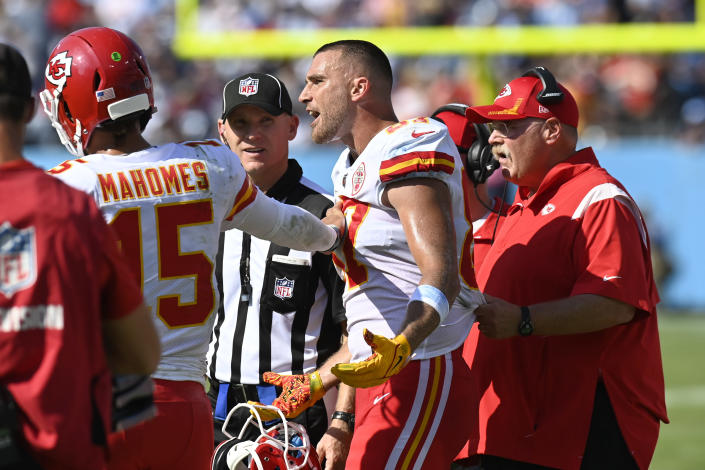 Kansas City Chiefs tight end Travis Kelce (87) is restrained by quarterback Patrick Mahomes (15) and head coach Andy Reid, right, as Kelce argues with an official in the second half of an NFL football game against the Tennessee Titans Sunday, Oct. 24, 2021, in Nashville, Tenn. (AP Photo/Mark Zaleski)