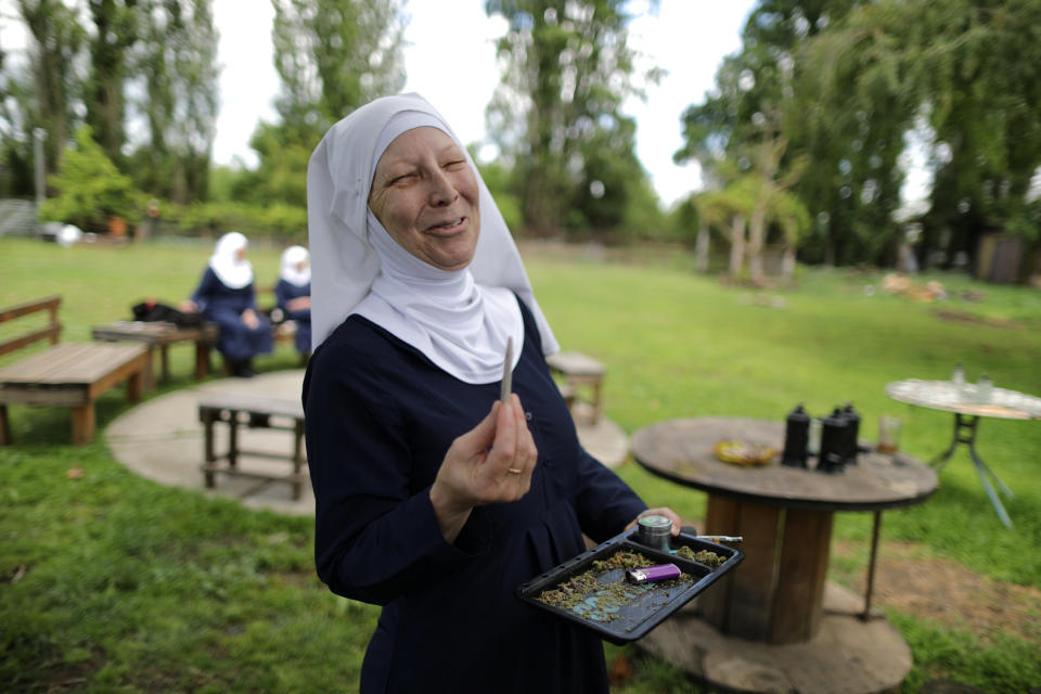 California "weed nun" Christine Meeusen, 57, lights a joint at Sisters of the Valley near Merced, California, U.S., April 18, 2017. Picture taken April 18, 2017. REUTERS/Lucy Nicholson