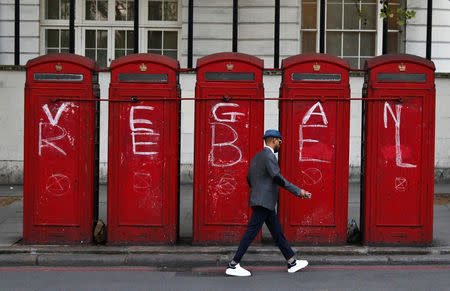 A man walks past phone boxes at Marble Arch during the Extinction Rebellion protest in London, Britain April 20, 2019. REUTERS/Kevin Coombs