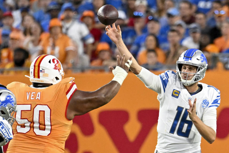 Detroit Lions quarterback Jared Goff (16) throws under pressure from Tampa Bay Buccaneers defensive tackle Vita Vea (50) during the second half of an NFL football game Sunday, Oct. 15, 2023, in Tampa, Fla. (AP Photo/Jason Behnken)