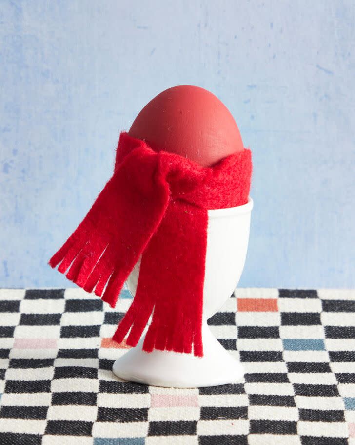 an easter egg decorated with a red scarf for taylor swift's red album