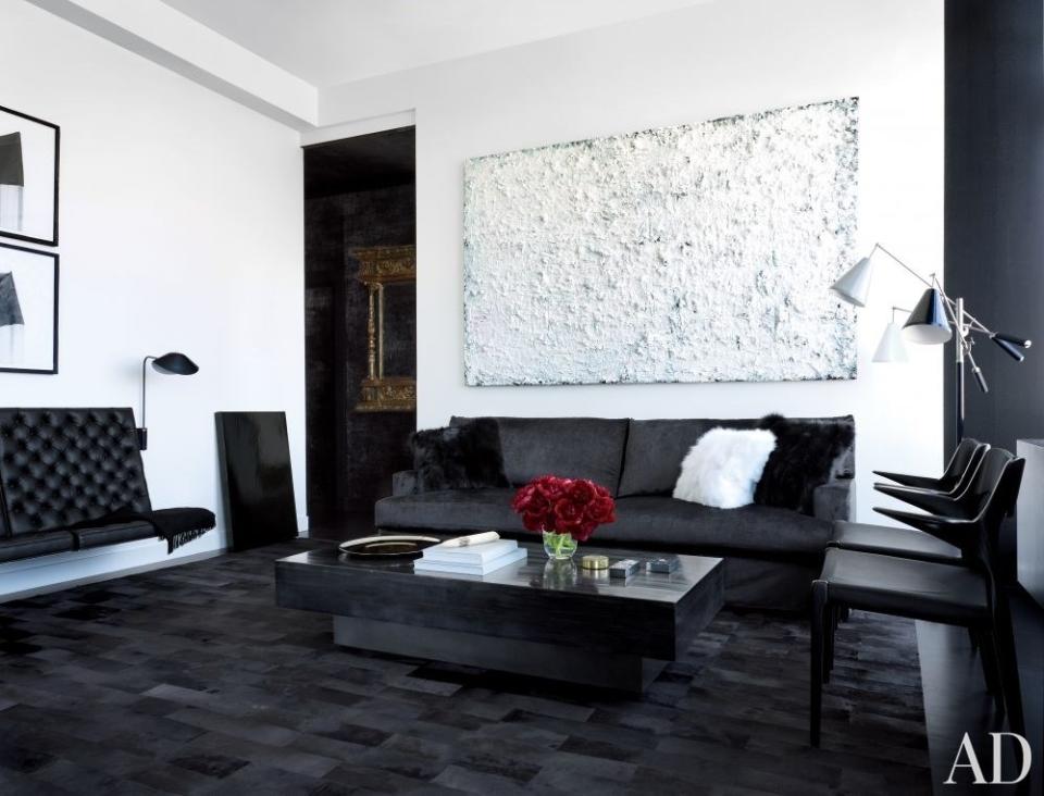 In Gilles Mendel's <a rel="nofollow noopener" href="https://www.architecturaldigest.com/story/gilles-mendel-manhattan-apartment-article?mbid=synd_yahoo_rss" target="_blank" data-ylk="slk:Manhattan living room;elm:context_link;itc:0;sec:content-canvas" class="link ">Manhattan living room</a>, painted in Ralph Lauren Pocket Watch White, an artwork by Rodney Dickson hangs above a custom-made sofa clad in a Pollack velvet; the floor lamp is by Arredoluce, and the fox-fur pillows and calfskin rug are by J. Mendel.