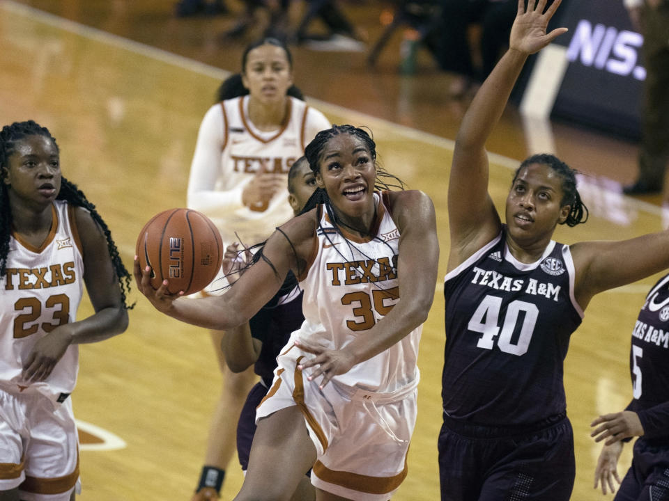 FILE - In this Dec. 6, 2020, file photo, Texas center Charli Collier (35) goes up to shoot against Texas A&M center Ciera Johnson (40) during the first half of an NCAA college basketball game in Austin, Texas. The Dallas Wings selected Collier with the first pick in the WNBA draft Thursday, April 15. (AP Photo/Michael Thomas, File)