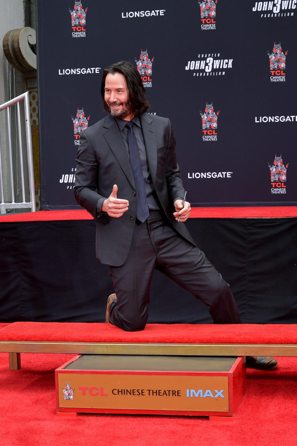 Reeves places his hands in cement at TCL Chinese Theatre IMAX in Hollywood, California.