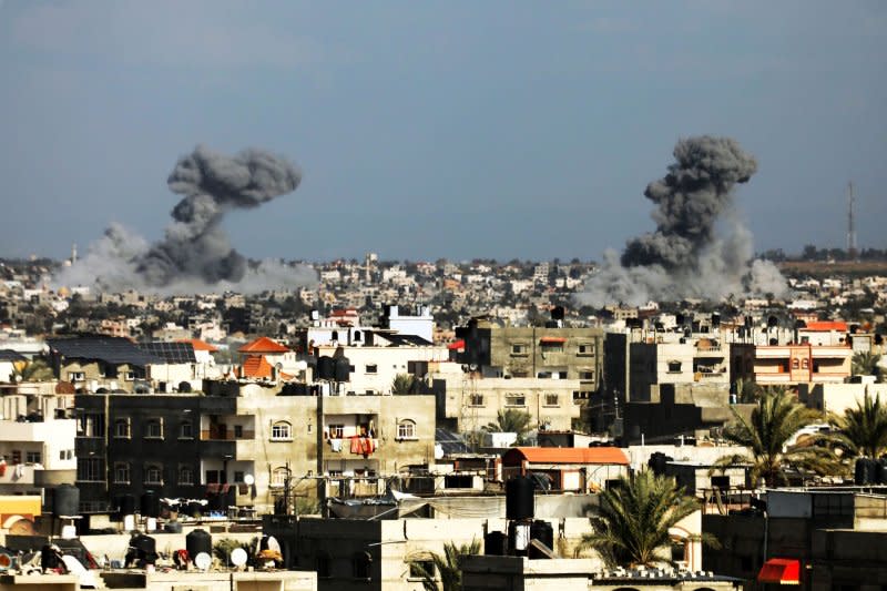 On Thursday, smoke rises over buildings in Khan Yunis during an Israeli bombardment. Israel's Defense Minister officially declared Hamas forces in Khan Younis defeated Thursday. Photo by Ismael Mohamad/UPI