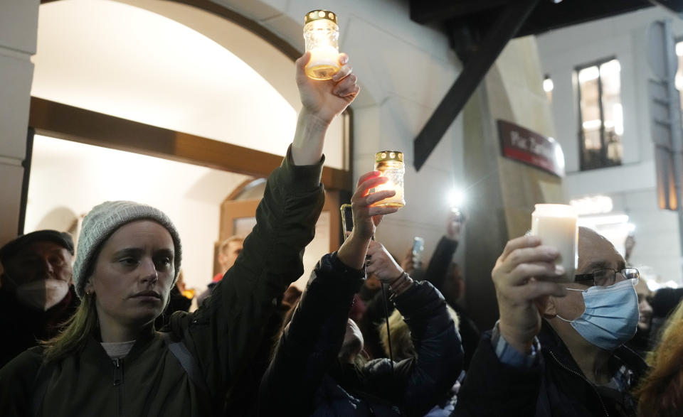 People gather in Warsaw, Poland, on Saturday, Nov. 6, 2021, to protest restrictive abortion law that critics say led to a recent death of a woman with troubled pregnancy. The protesters are holding portraits of the woman, 30-year-old Iza, who died in hospital from septic shock. (AP Photo/Czarek Sokolowski)