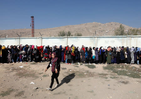 Afghan women line up to cast their votes during the parliamentary election at a polling station in Kabul, Afghanistan October 21, 2018. REUTERS/Omar Sobhani