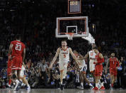 FILE - In this April 8, 2019, file photo, Virginia's Kyle Guy (5) and his teammates celebrate after defeating Texas Tech 85-77 in overtime in the championship of the Final Four NCAA college basketball tournament in Minneapolis. (AP Photo/David J. Phillip, File)