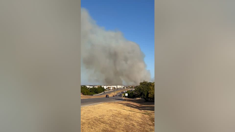 Plumes of smoke hover over an area in Cedar Park, Texas, where a large brush fire was ignited Tuesday. - Courtesy Ramon Valeriano/Facebook