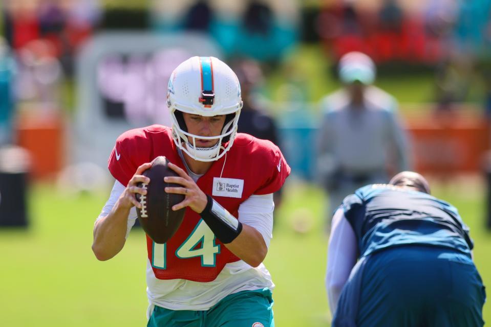 Aug 15, 2024; Miami Gardens, FL, USA; Miami Dolphins quarterback Mike White (14) drops back during joint practice with the Washington Commanders at Baptist Health Training Complex. Mandatory Credit: Sam Navarro-USA TODAY Sports