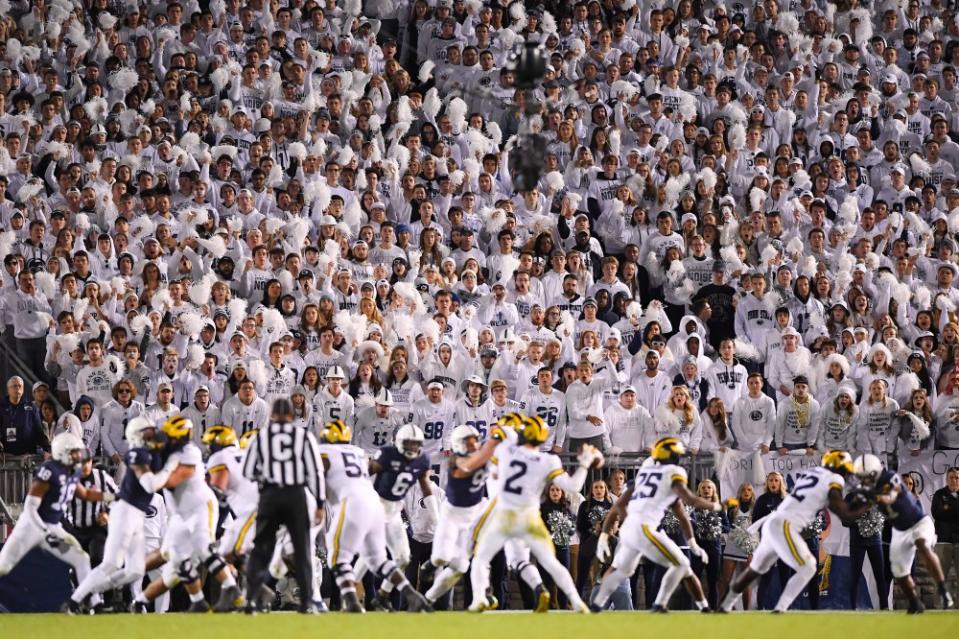 Oct. 19, 2019; University Park, Pennsylvania; Fans cheer as Michigan Wolverines quarterback Shea Patterson (2) throws a pass against the Penn State Nittany Lions during the fourth quarter at Beaver Stadium. Rich Barnes-USA TODAY Sports