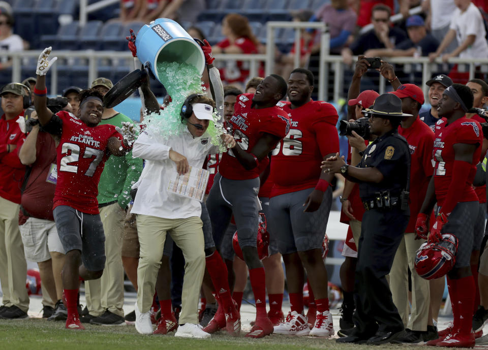 Florida Atlantic head coach Lane Kiffin is doused as his team celebrates defeating UAB in an NCAA college football game for the Conference USA championship, Saturday, Dec. 7, 2019, in Boca Raton, Fla. (Mike Stocker/South Florida Sun-Sentinel via AP)