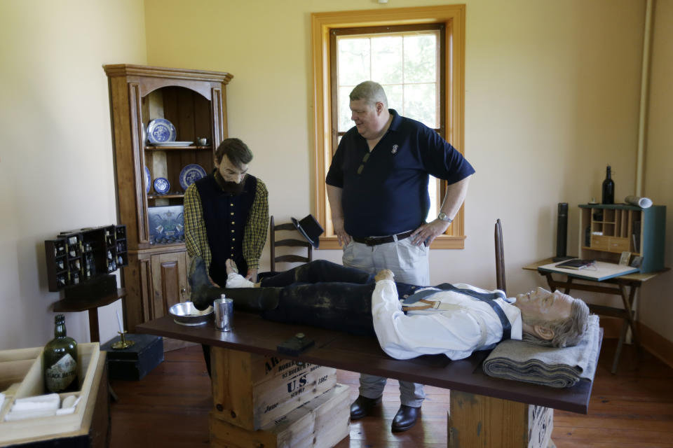 George Wunderlich, director of the National Museum of Civil War Medicine, poses for a portrait with a depiction of an operating theater in the Pry House Field Hospital Museum Friday, June 21, 2013, in Keedysville, MD. The house is located on the Antietam Battlefield, which served both as Union General George McClellan's and Union Army Maj. Dr. Jonathan Letterman's headquarters during the battle. As gunshots ravaged the bodies of tens of thousands of soldiers at the Battle of Gettysburg, military doctors responded with a method of treatment that is still the foundation of combat medicine today. (AP Photo/Matt Rourke)