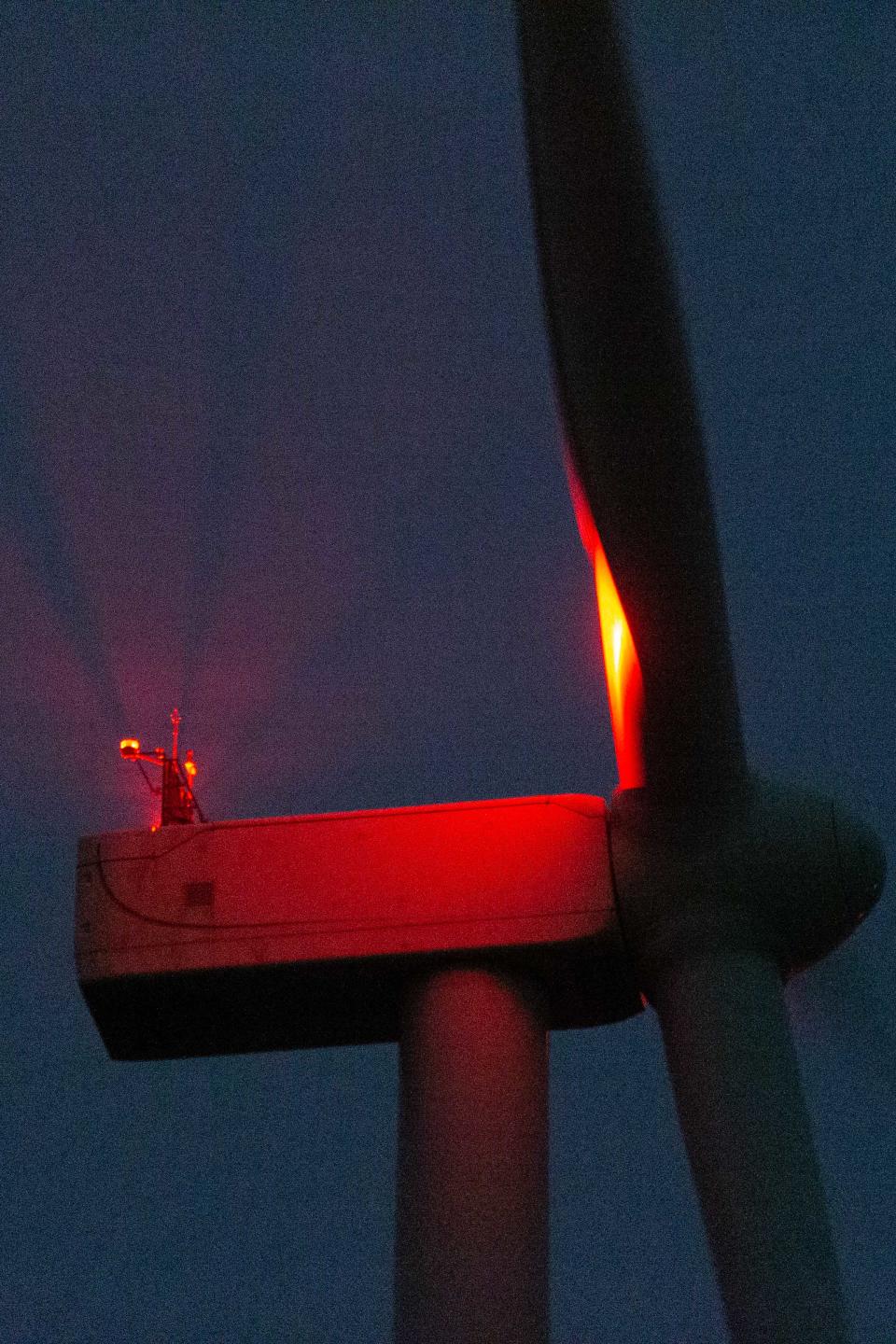 A flashing red light blinks atop a wind turbine in Allen County.