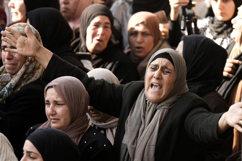 Palestinian women mourn Ahmed Daraghmeh during his funeral in the West Bank city of Nablus, Thursday, Dec. 22, 2022. Palestinian medics say Israeli forces have shot dead the 23-year-old man and wounded several others during clashes in the occupied West Bank. Daraghmeh was mortally wounded early Thursday when Palestinian militants exchanged fire with Israeli troops that entered the city of Nablus to escort Jewish worshippers to a site known as the biblical Joseph's Tomb in the Palestinian city. (AP Photo/Majdi Mohammed)