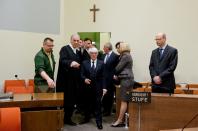 Formula One boss Bernie Ecclestone, center, arrives in the regional court in in Munich, Germany, Thursday, April 24, 2014. Ecclestone is charged with bribery and incitement to breach of trust "in an especially grave case" over a US$ 44 million payment to a German banker, that prosecutors allege was meant to facilitate the sale of the Formula One Group to a buyer of Ecclestone's liking. (AP Photo/Sven Hoppe, pool)