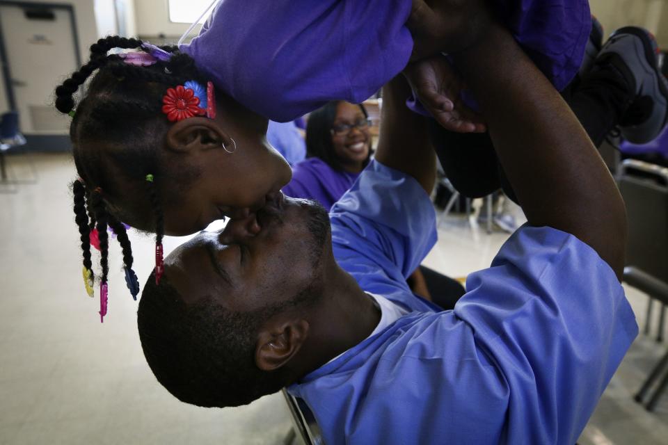 Tylan Gregory plays with his daughter during a "Get On the Bus" visiting day to Folsom State Prison