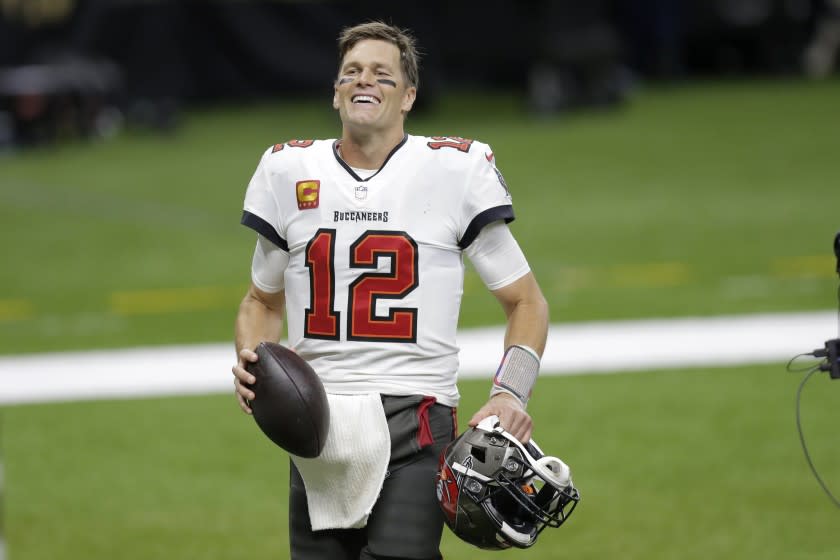 Tampa Bay Buccaneers quarterback Tom Brady smiles after an NFL divisional round playoff football game.