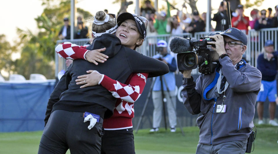 Lydia Ko, second from left, of New Zealand, hugs Nelly Korda, left, after Korda won the LPGA Drive On Championship golf tournament at Bradenton Country Club, Sunday, Jan. 28, 2024, in Bradenton, Fla. (AP Photo/Steve Nesius)