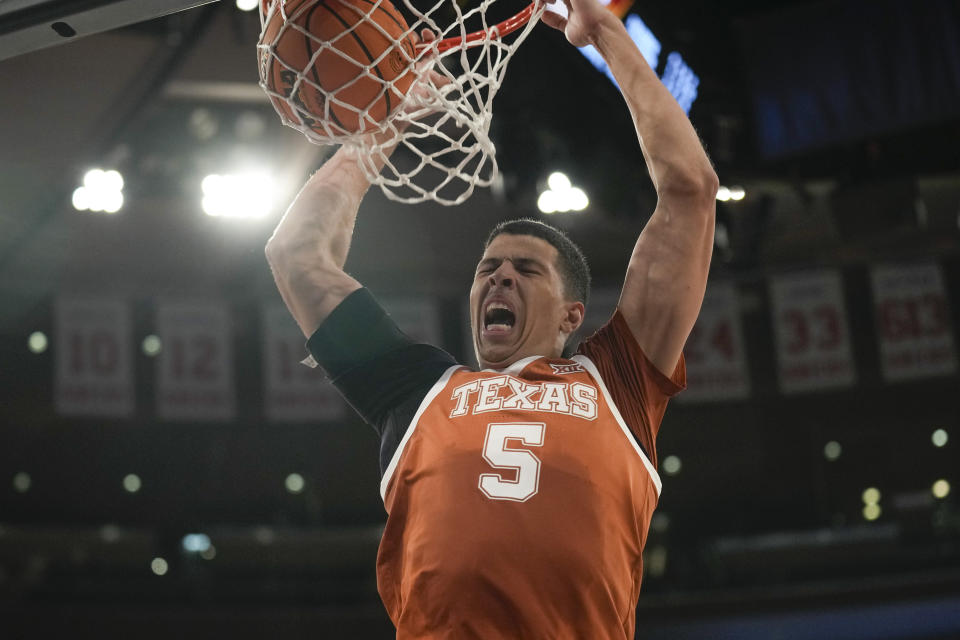 Texas's Kadin Shedrick dunks the ball during the second half of an NCAA college basketball game against Louisville, Sunday, Nov. 19, 2023, in New York. (AP Photo/Seth Wenig)