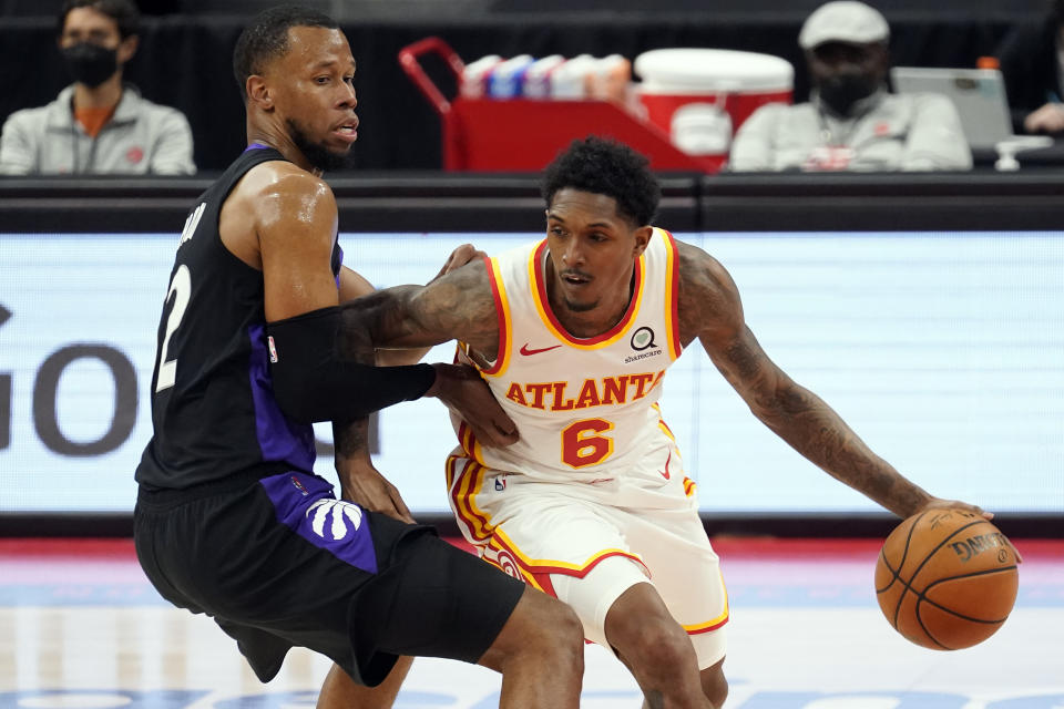 Atlanta Hawks guard Lou Williams (6) drives around Toronto Raptors guard Rodney Hood (32) during the second half of an NBA basketball game Tuesday, April 13, 2021, in Tampa, Fla. (AP Photo/Chris O'Meara)