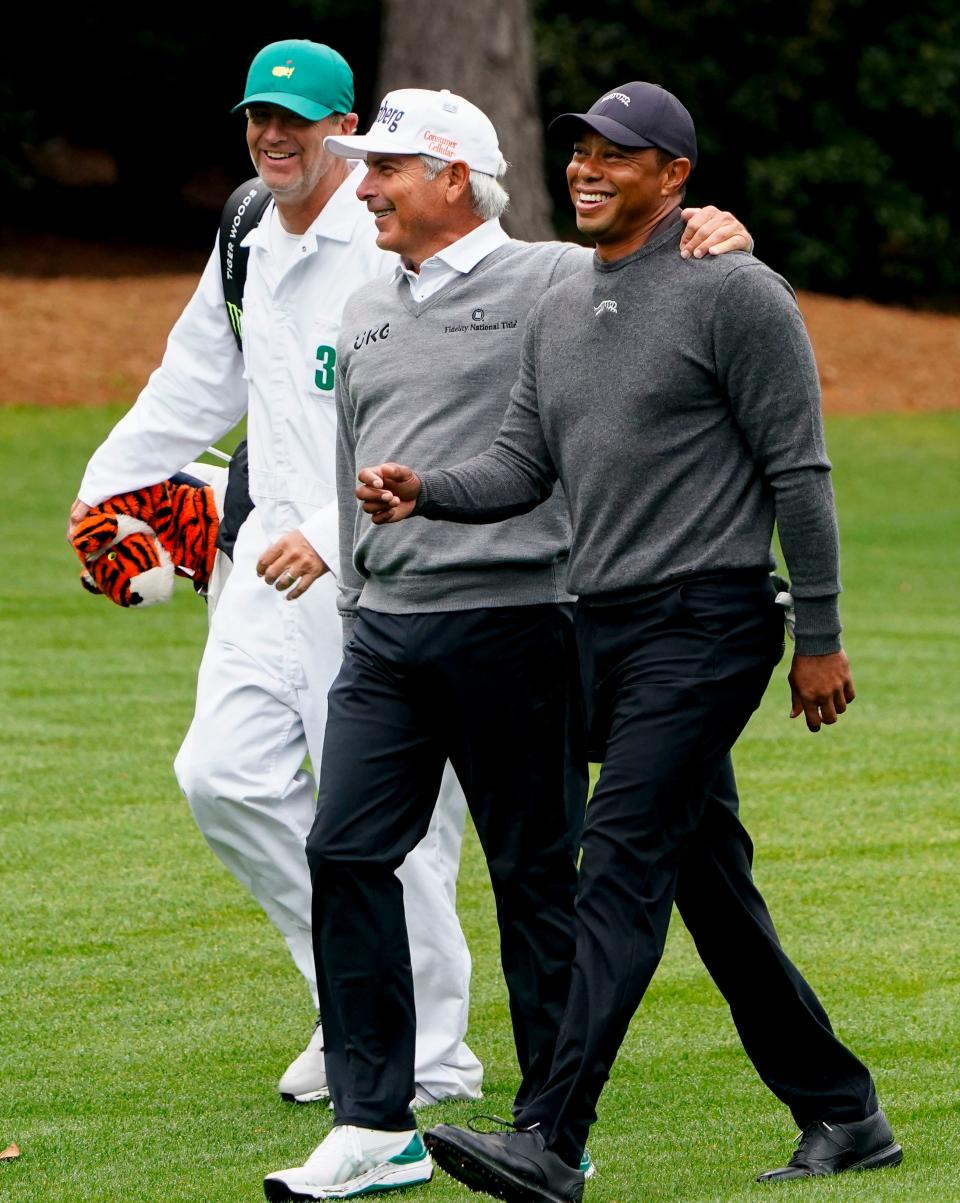 Tiger Woods and his caddie Lance Bennett walk down the No. 5 fairway at Augusta National Golf Course with former Masters champ Fred Couples during a practice round for the 2024 Masters Tournament.