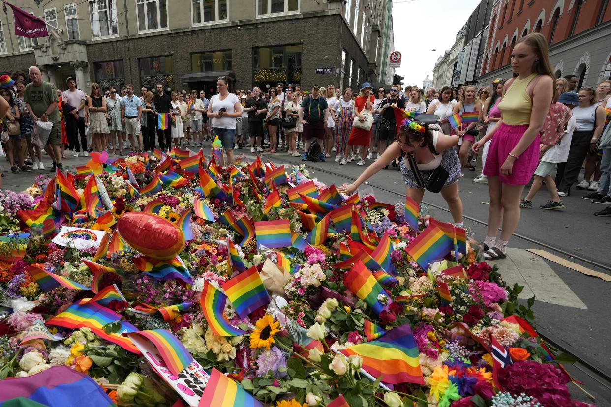 People lay flowers at the shooting site in Oslo.