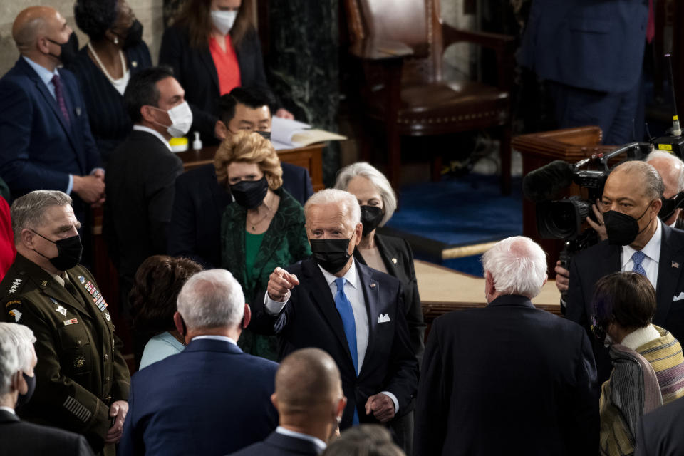 WASHINGTON, DC - APRIL 28:   President Joe Biden speaks with lawmakers as he exits the House chamber at the end of his address to the joint session of Congress in the House chamber of the U.S. Capitol April 28, 2021 in Washington, DC. On the eve of his 100th day in office, Biden will speak about his plan to revive America's economy and health as it continues to recover from a devastating pandemic. He will deliver his speech before 200 invited lawmakers and other government officials instead of the normal 1600 guests because of the ongoing COVID-19 pandemic. (Photo by Caroline Brehman - Pool/Getty Images)