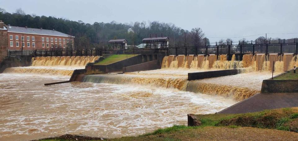 Water flows Tuesday at the mill pond in downtown Prattville.