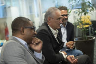 Brazil's national soccer coach Adenor Leonardo Bachi, also known as Tite, center, assistant coaches Cesar Sampaio, left, and Cleber Xavier give an interview in Rio de Janeiro, Brazil, Thursday, Oct. 6, 2022. (AP Photo/Bruna Prado)