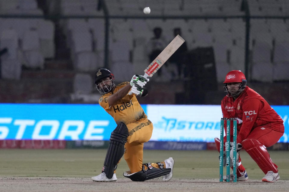 Peshawar Zalmi' Babar Azam, left, plays a shot as Islamabad United Azam Khan watches during the Pakistan Super League T20 cricket eliminator match between Islamabad United and Peshawar Zalmi, in Karachi, Pakistan, Saturday, March 16, 2024. (AP Photo/Fareed Khan)