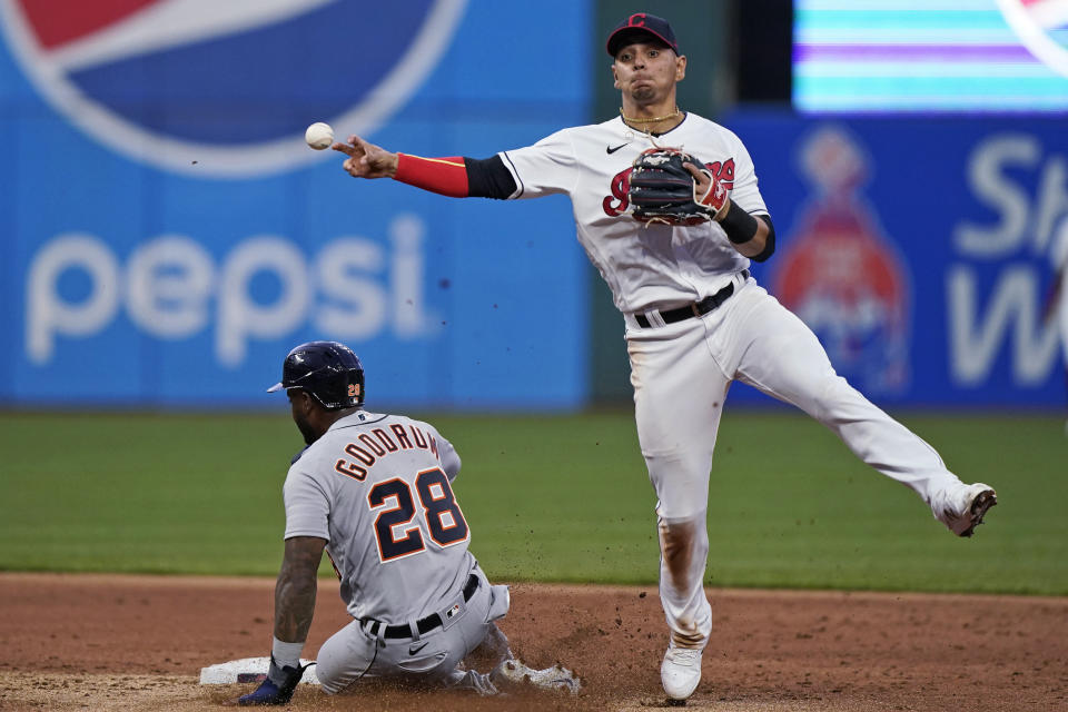 Cleveland Indians' Andres Gimenez throws to first base after getting Detroit Tigers' Niko Goodrum out at second base during the third inning in a baseball game Friday, April 9, 2021, in Cleveland. JaCoby Jones was out at first base for the double play. (AP Photo/Tony Dejak)