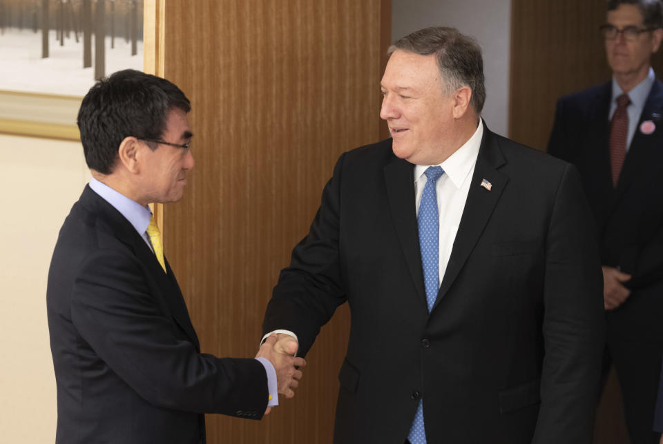 U.S. Secretary of State Mike Pompeo, center, shakes hands with Japan's Foreign Minister Taro Kono before a meeting in Tokyo Saturday, Oct. 6, 2018. (Pool Photo via AP)