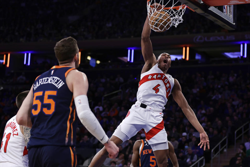 Toronto Raptors forward Scottie Barnes (4) dunks in front of New York Knicks center Isaiah Hartenstein during the first half of an NBA basketball game, Monday, Jan. 16, 2023, in New York. (AP Photo/Adam Hunger)