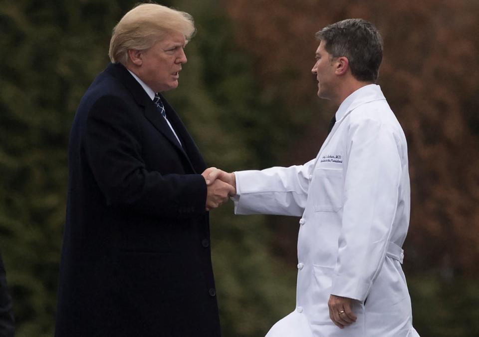 Donald Trump (left) shakes hands with Ronny Jackson (right) in 2018. The former president forgot Jackson’s name seconds after challenging Joe Biden to a cognitive test (AFP via Getty Images)
