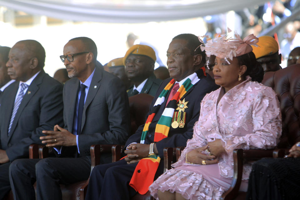 Zimbabwean President Emmerson Mnangagwa is seen with his wife Auxilia Mnangagwa, during his inauguration ceremony at the National Sports Stadium in Harare, Sunday, Aug. 26, 2018. The Constitutional Court upheld Mnangagwa's narrow election win Friday, saying the opposition did not provide " sufficient and credible evidence" to back vote- rigging claims. South African President Cyrill Ramaphosa, left, and Rwanda President Paul Kagame, 2nd left. (AP Photo/Tsvangirayi Mukwazhi)