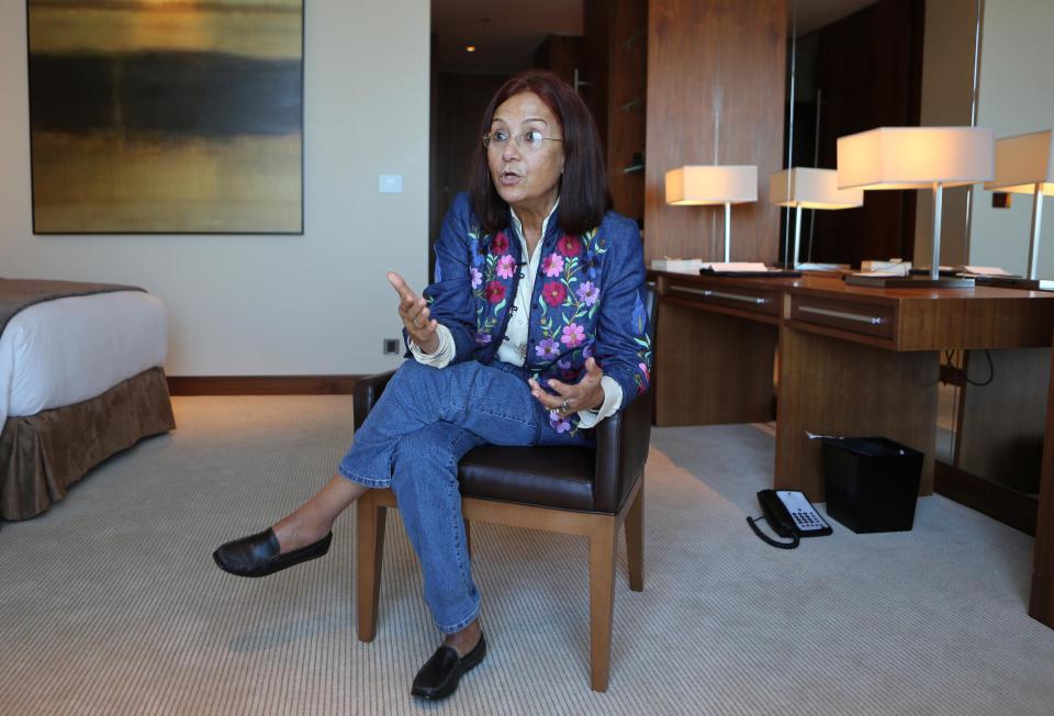 In this Thursday Nov. 7, 2013 photo, Egyptian jewelry designer Azza Fahmy talks with an Associated Press reporter in her hotel room in Dubai, United Arab Emirates. Fahmy, who has been approached by a massive project called the Dubai Design District, or D3, as an adviser, is an icon among young Arab artisans for successfully infusing Egyptian and Islamic art into wearable, modern pieces. She created a line of jewelry for the British Museum inspired by the Muslim Hajj pilgrimage, and her jewelry will be on the runway Sunday, Feb. 16, 2014, during London's Fashion Week, for designer Matthew Williamson's show. (AP Photo/Kamran Jebreili)