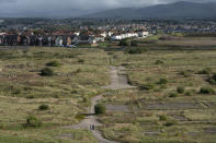 Members of the public walk on the site of a proposed new coal mine near the Cumbrian town of Whitehaven in northwest England, Monday, Oct. 4, 2021. A proposal to dig a new coal mine here is dividing the British government just as it prepares to host a major climate conference. West Cumbria Mining wants to build Britain's first deep coal mine in three decades to extract coking coal, which is used to make steel. The coal would be processed in Whitehaven, 340 miles (550 kilometers) northwest of London. But environmentalists are horrified by the idea. (AP Photo/Jon Super)