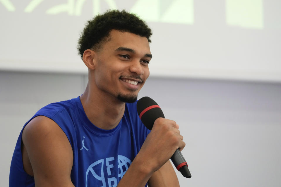 France's basketball player Victor Wembanyama, who plays for the NBA San Antonio Spurs, smiles while speaking during media day at the French National Institute of Sport and Physical Education, in Vincennes, outside Paris, Thursday, June 27, 2024. (AP Photo/Thibault Camus)