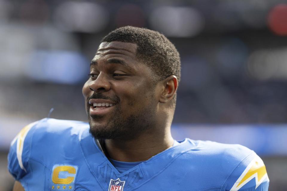 Chargers linebacker Khalil Mack (52) smiles with his helmet off before a game