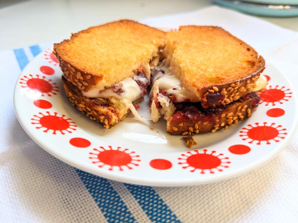 grilled cheese sandwich sitting on a red and white plate