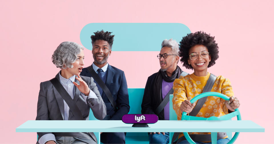 Four people in a simulated car with a Lyft logo.