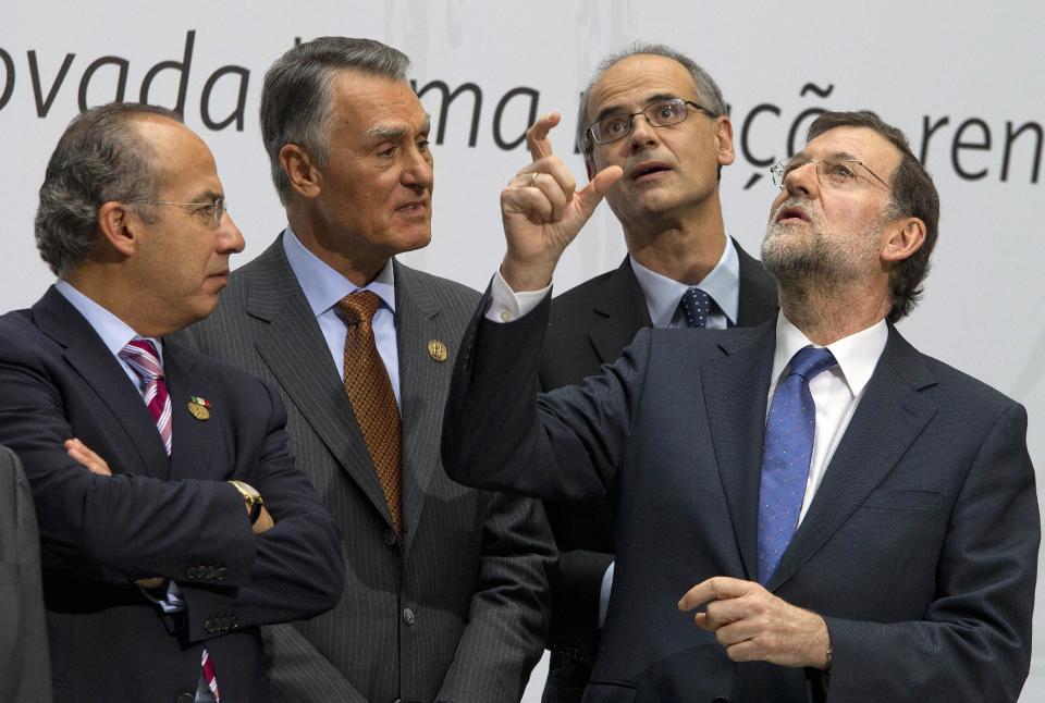 Spain's Prime Minister Mariano Rajoy, right, Andorra's Head of Government Antoni Marti, second right, Portugal's President Cavaco Silva, second left, and Mexico's President Felipe Calderon, left, talk as they posse for a photo at the XXII Iberoamerican summit in the southern Spanish city of Cadiz, Saturday, Nov. 17, 2012. Spain's King Juan Carlos opened the annual Iberoamerican summit, which brings together the heads of Spain and Portugal and the leaders of Latin America to discuss political issues and arrange business deals. (AP Photo/Miguel Angel Morenatti)