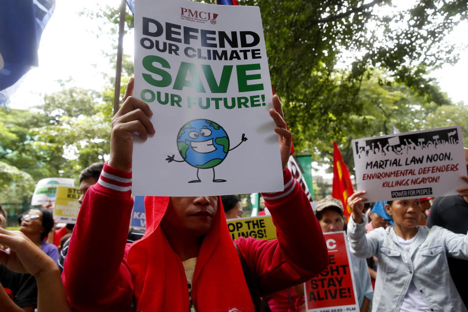 Environmental activists hold placards during a rally outside the Department of Environment and Natural Resources to coincide with the global protests on climate change Friday, Sept. 20, 2019 at suburban Quezon city, northeast of Manila, Philippines. Various environmental groups in the country are participating in what is expected to be the world's largest mobilization on climate change known as "Global Climate Strikes." (AP Photo/Bullit Marquez)