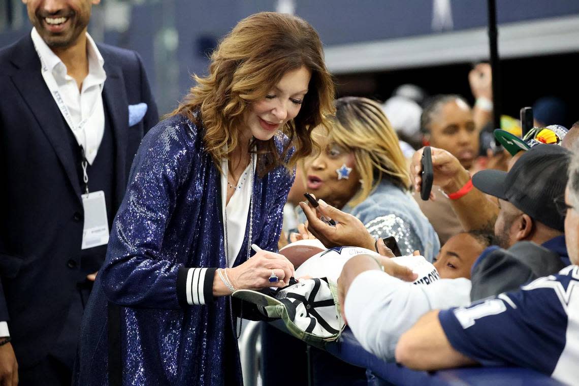 Charlotte Jones, the Dallas Cowboys’ executive vice president and chief brand officer, signs autographs before the start of the game on Nov. 23, 2023, at AT&T Stadium in Arlington.