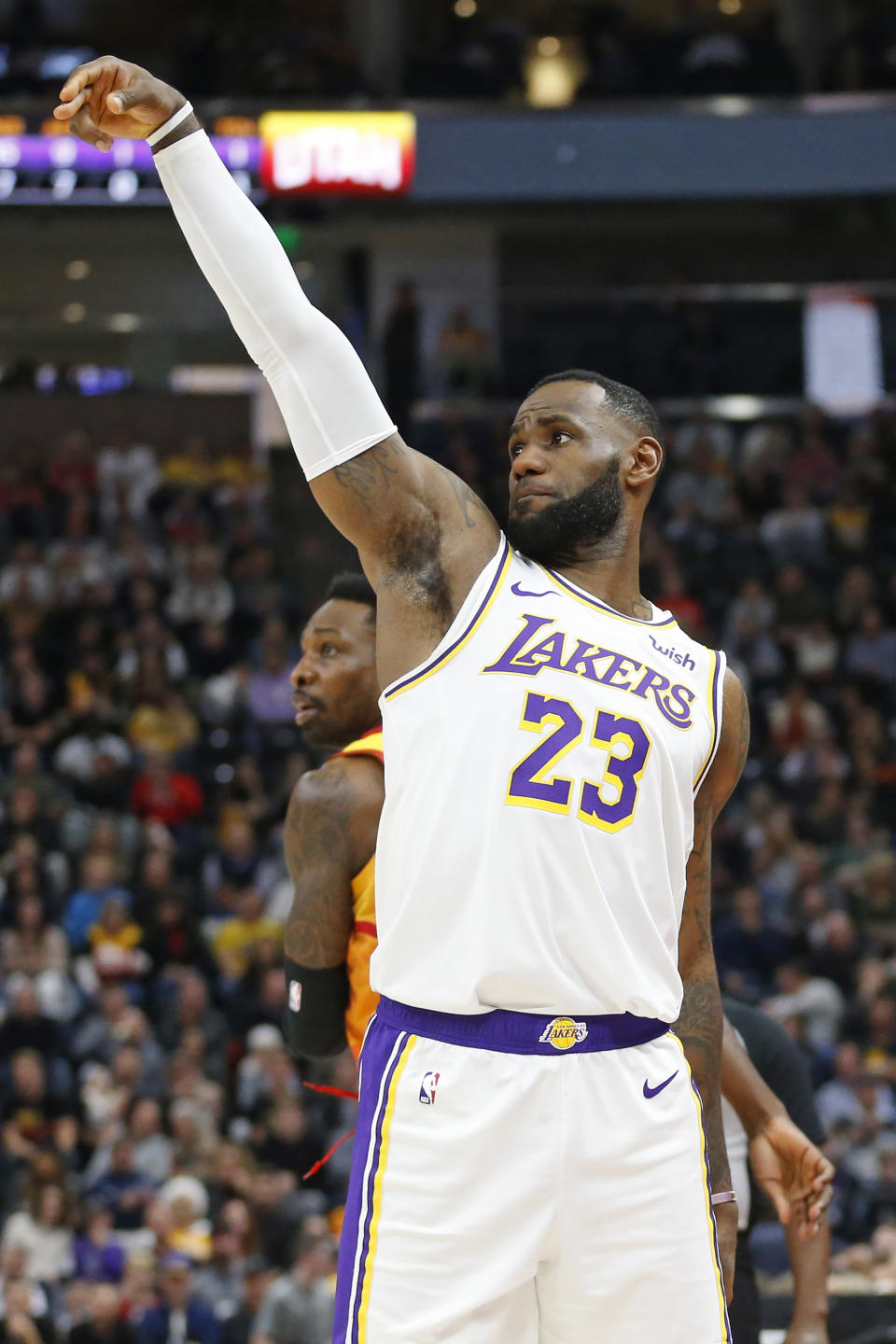 Los Angeles Lakers forward LeBron James (23) follows through after shooting a 3-pointer against Utah Jazz forward Jeff Green, rear, in the first half during an NBA basketball game Wednesday, Dec. 4, 2019, in Salt Lake City. (AP Photo/Rick Bowmer)