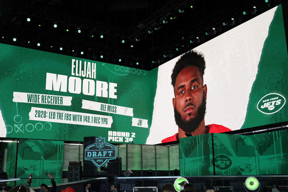 Images are displayed on stage of Elijah Moore, wide receiver at Mississippi, selected by the New York Jets in the second round of the NFL football draft, Friday, April 30, 2021, in Cleveland. (AP Photo/Tony Dejak)