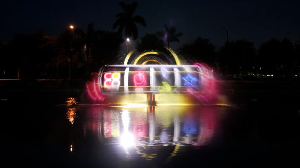 A 20,000-lumen  projector displays images onto a 70-foot-by-30-foot water screen,  giving the appearance  of massive “floating  holograms” to onlookers.